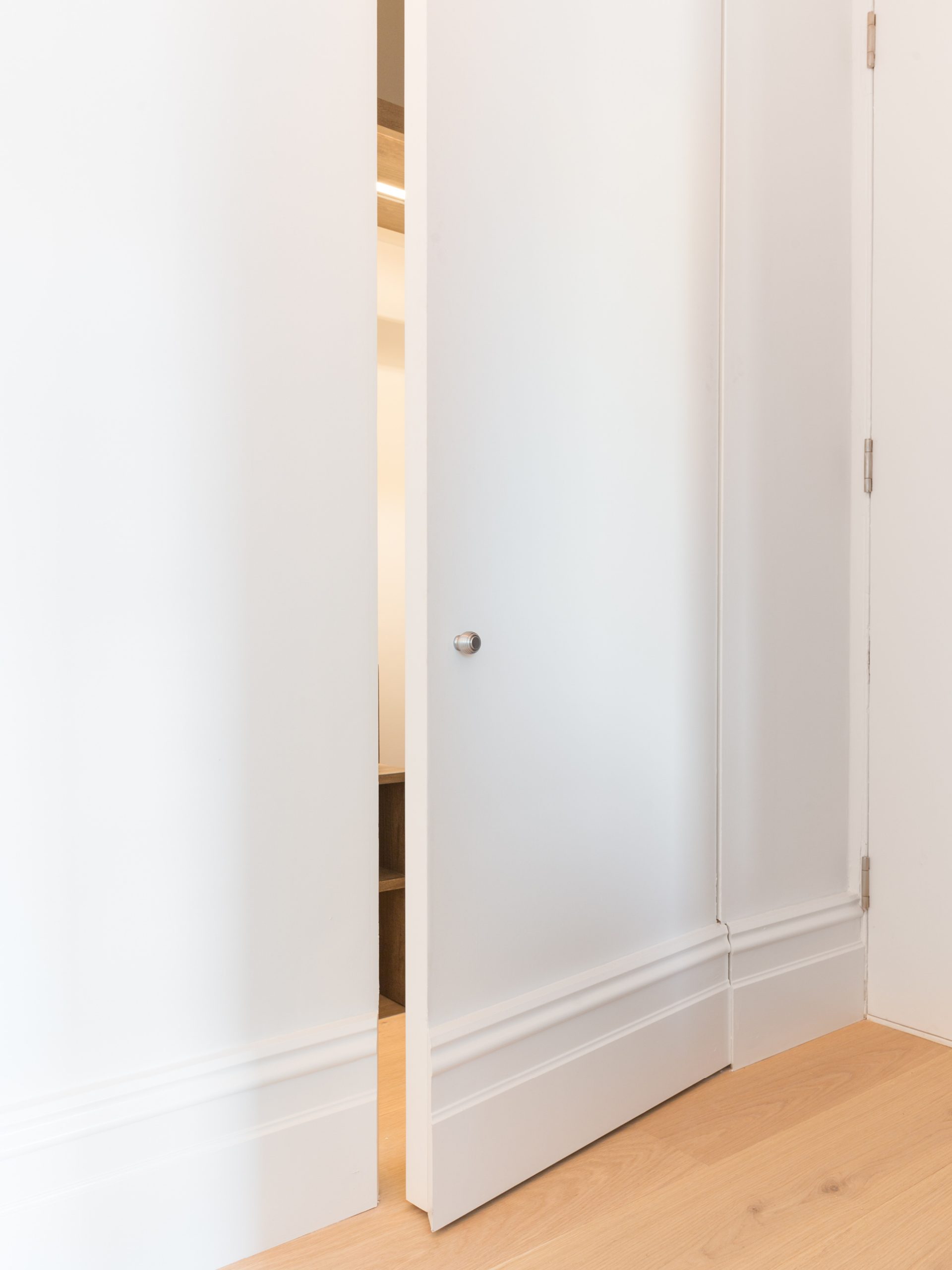 Bloomsbury Apartment - Hallway - Pivot door to cloaks cupboard - Open