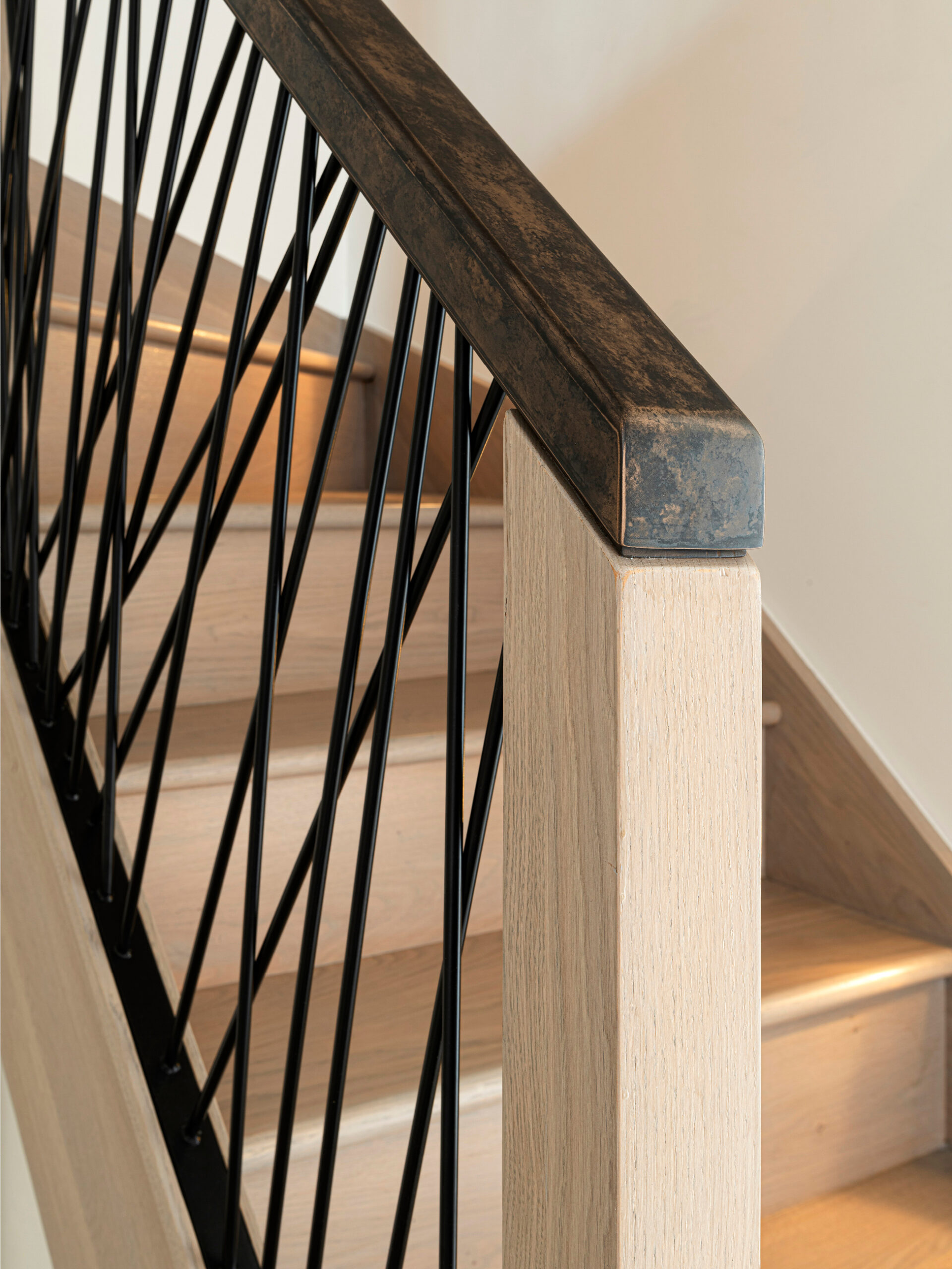 Bespoke metal and oak staircase with liquid metal feature handle