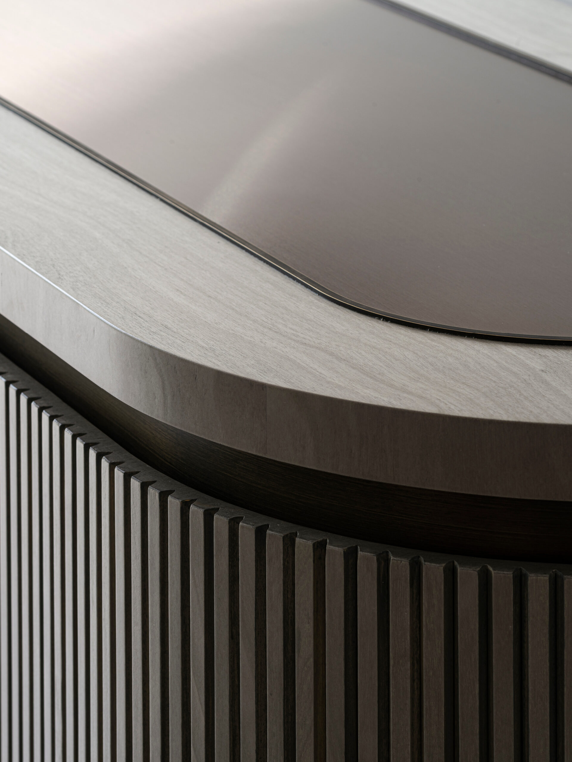 Fluted curved veneered side board with bronze inset top