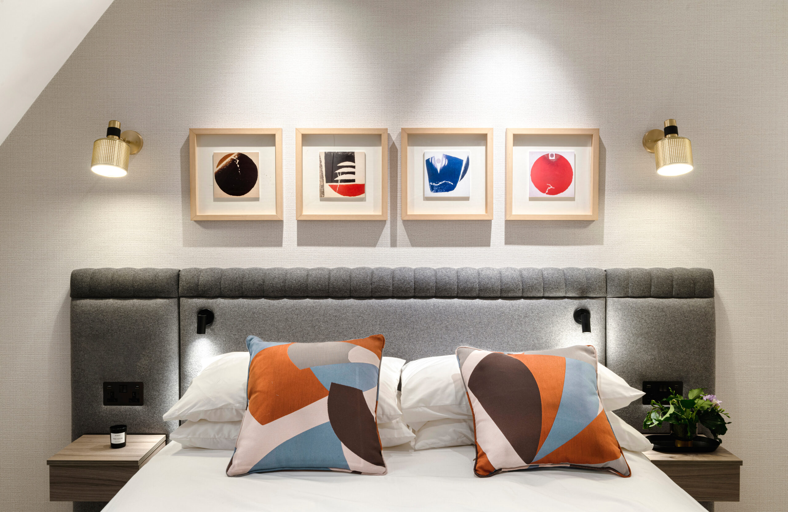 Colourful headboard with blue and orange cushions