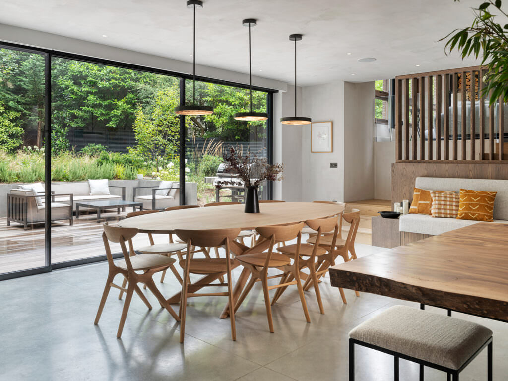 LLI Design - Highgate - Modern Minimalism Home Highgate Minimal Modernism: kitchen and dining space with oak table and glazing to the garden