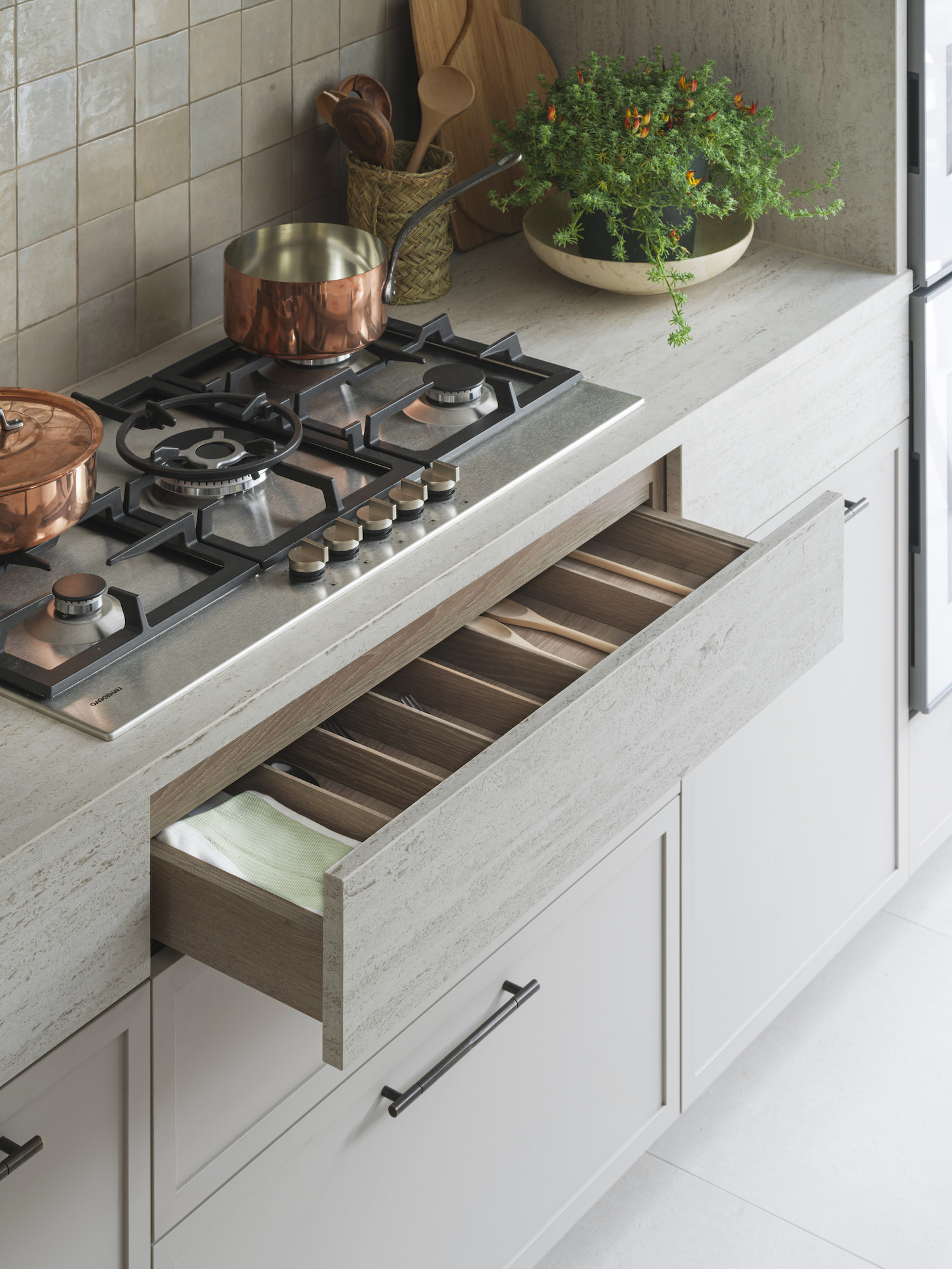 Chelsea Townhouse - LLI Design - Bespoke Kitchen - Concealed stone drawer below Gaggenau gas hob - Open