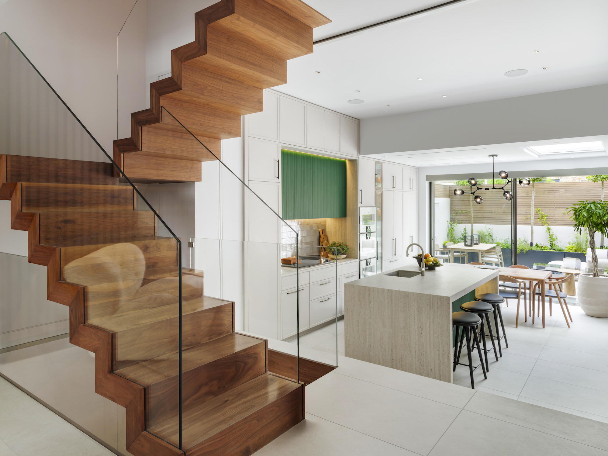 Chelsea Townhouse - LLI Design - Bespoke Kitchen - Kitchen with statement glass and walnut staircase