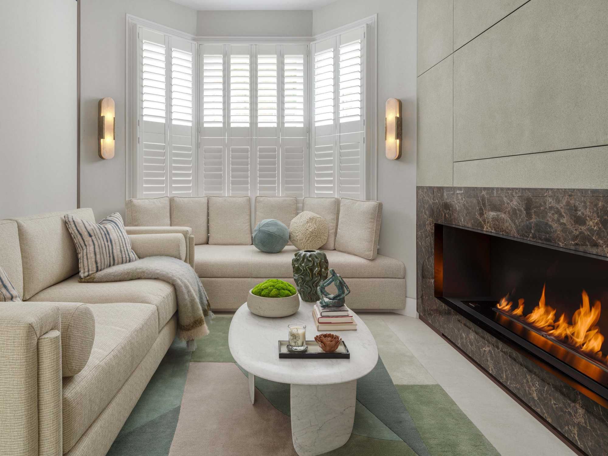 Chelsea Townhouse - LLI Design - Living Room - Overview with plantation shutters and brass and alabaster wall lights - TV closed