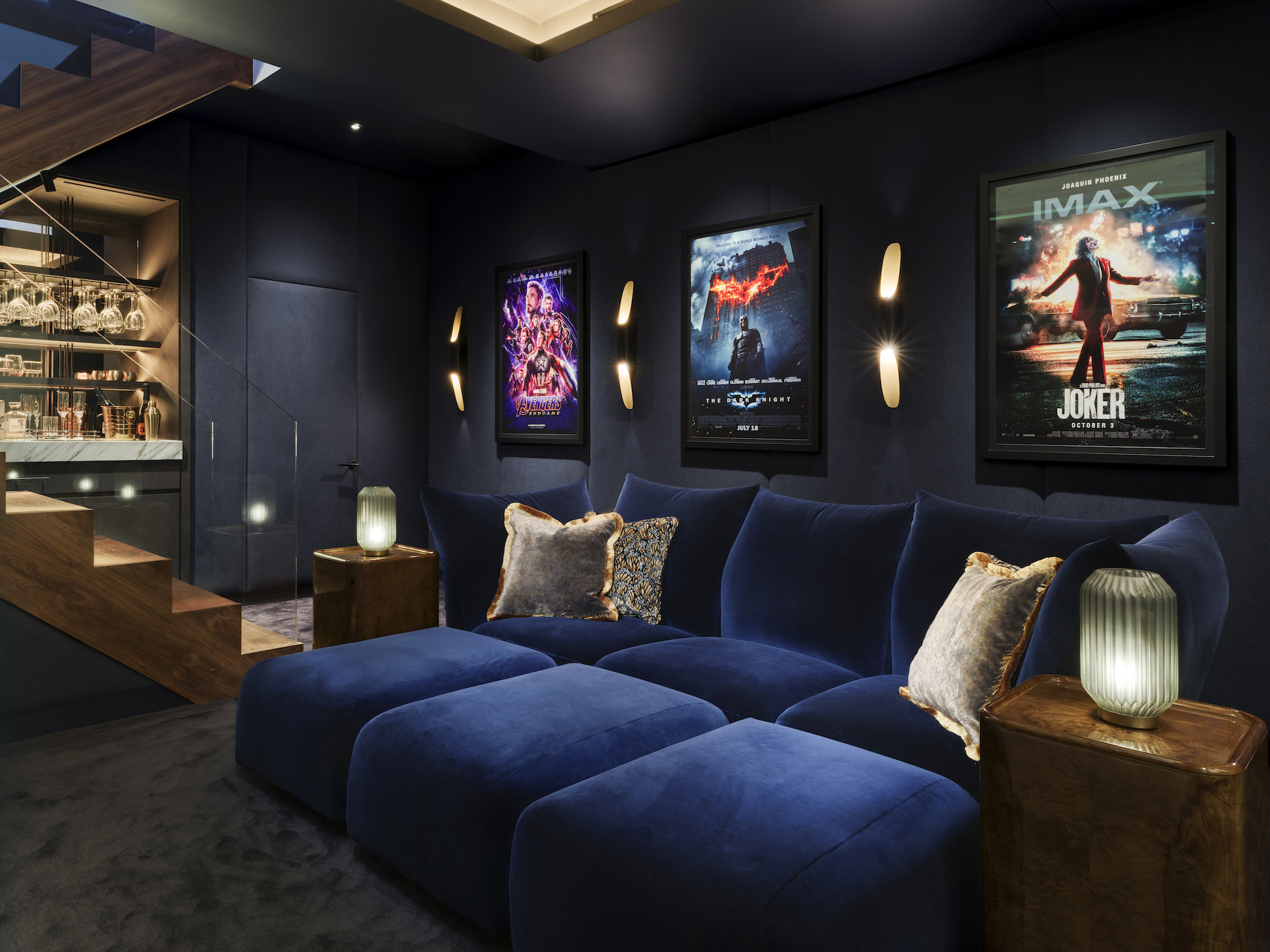 Chelsea Townhouse - LLI Design - Cinema Room - Overview 3 - Oversized navy day bed with upholstered walls behind - orange DMX lighting