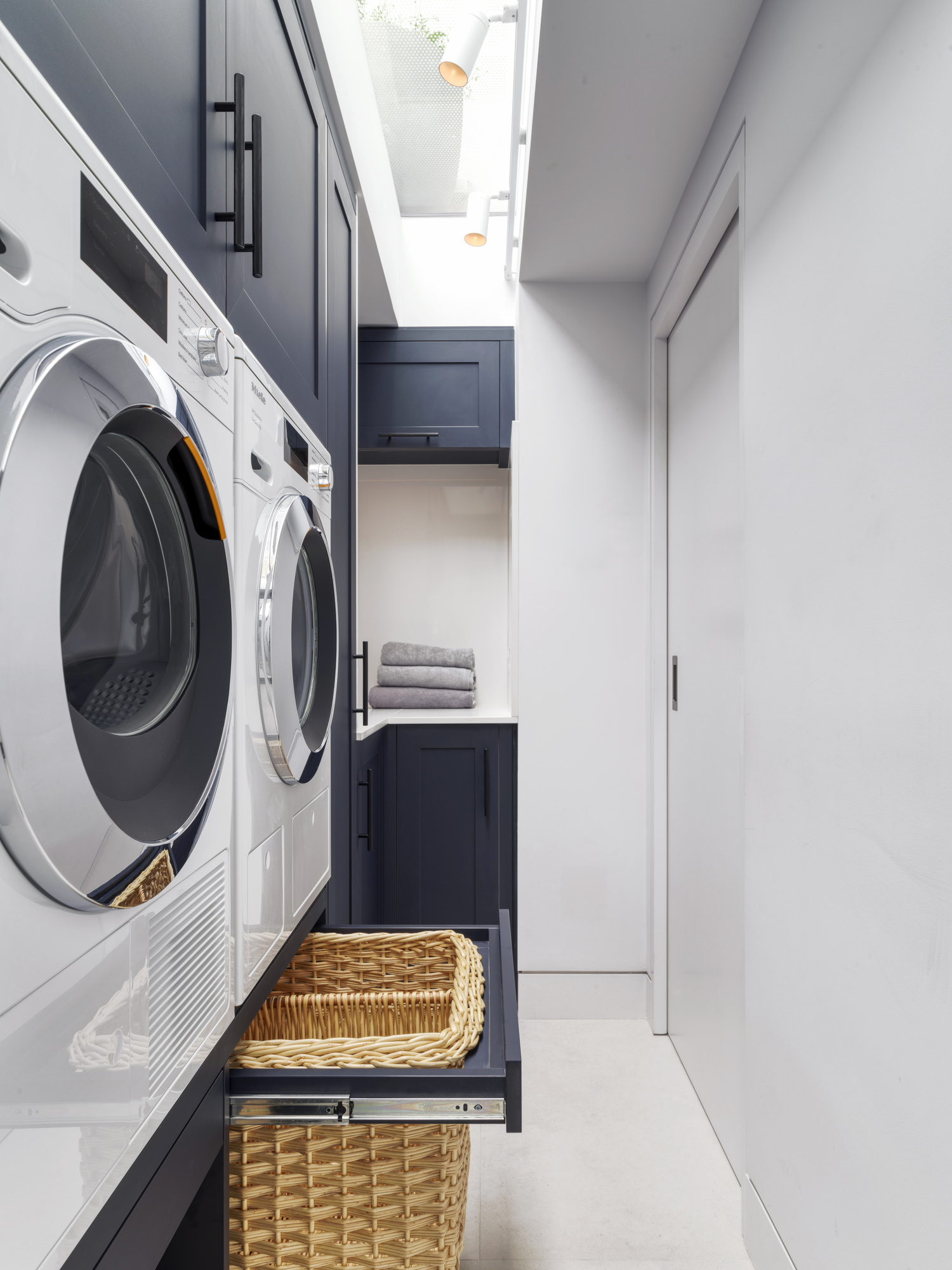 Chelsea Townhouse - LLI Design - Utility Room - Bespoke blue MFC joinery with integrated appliances - baskets open