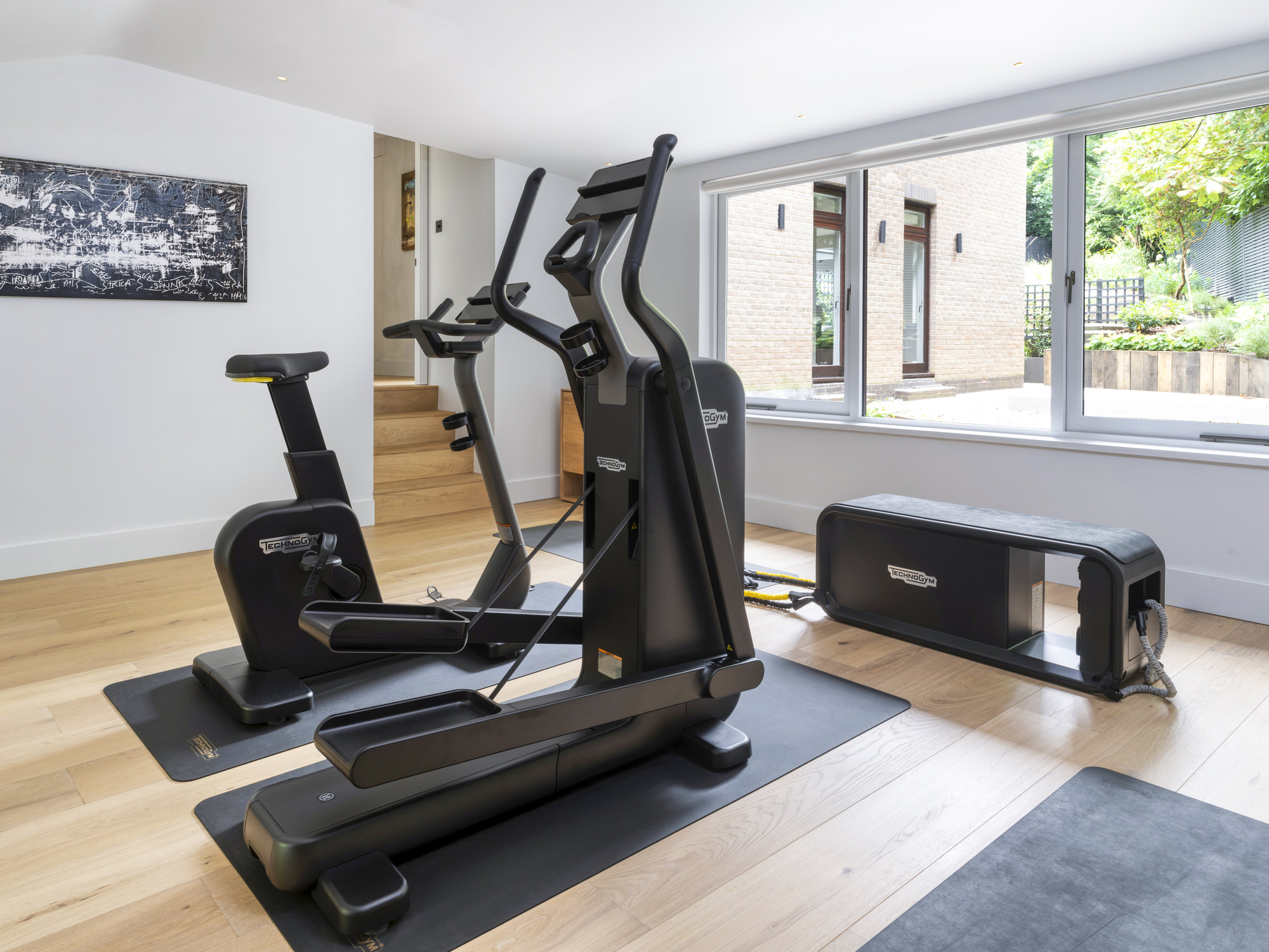 Highgate Minimal Modernism - LLI Design - Gym - with view to garden beyond