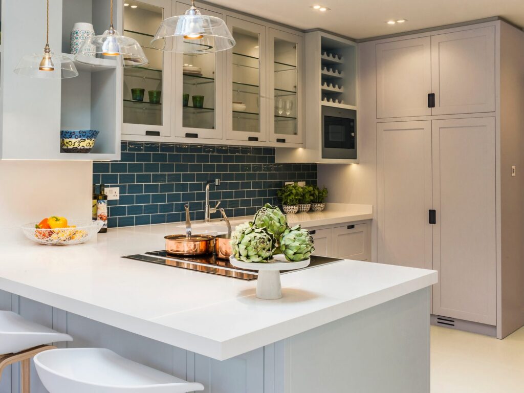 LLI Design - Portfolio Tile - 1 Edwardian family home, Highgate: bespoke painted kitchen with blue tiled splashback and glass pendants